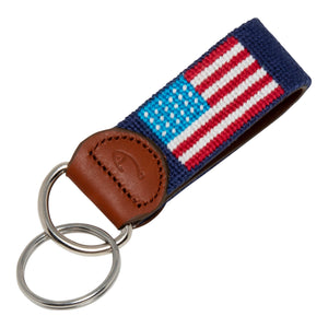 Hand-stitched American Flag needlepoint keychain showing American Flag on both sides against a navy blue background and leather backing.  Stainless steel D-ring and keyring.