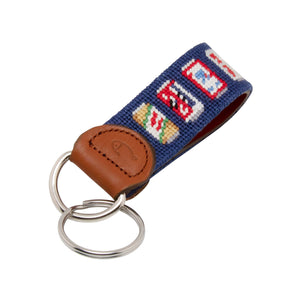 Hand-stitched Beer Can needlepoint keychain showing popular beer can pattern on both sides against a navy blue background and leather backing.  Stainless steel D-ring and keyring.