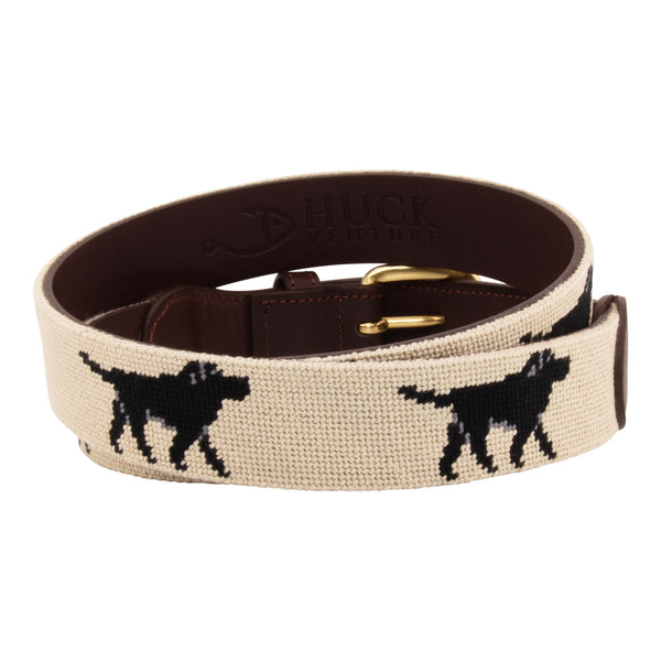 Black Lab Needlepoint Belt with khaki background showing a repeating pattern of evenly spaced black labradors. Belt has a brass buckle and full grain leather backing and strap.
