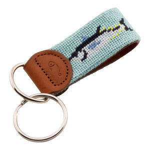 Hand-stitched bluefin tuna needlepoint keychain showing a bluefin tuna on both sides against a light blue background and leather backing.  Stainless steel D-ring and keyring.
