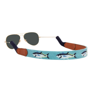 Bluefin tuna themed needlepoint sunglass strap showing a bluefin tuna design against a sea blue background with sturdy cotton covered silicone ear connectors and a soft leather backing