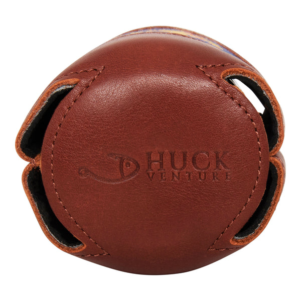 Bottom view handstitched needlepoint can cooler showing full grain soft leather exterior neoprene liner keeping 12 ounce beverage can cold Huck Venture logo Stamped in leather