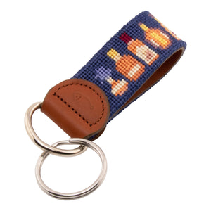 Hand-stitched bluefin tuna needlepoint keychain showing a bluefin tuna on both sides against a light blue background and leather backing.  Stainless steel D-ring and keyring.
