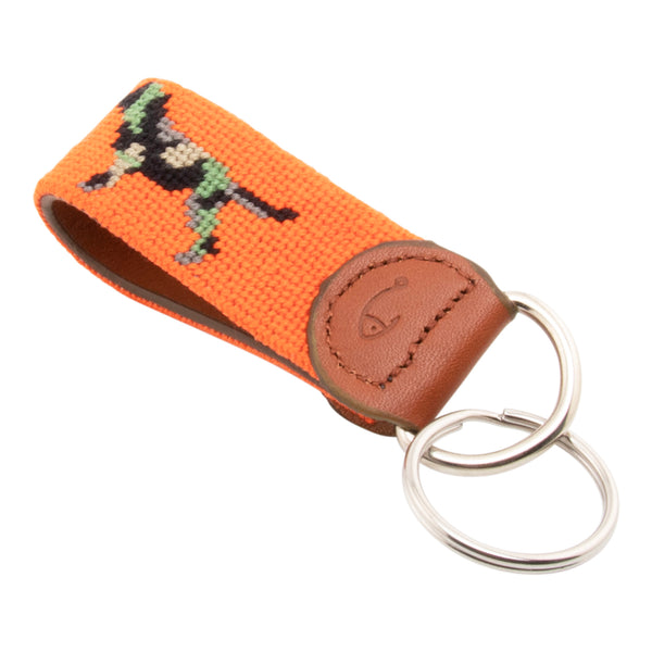 Needlepoint keychain with jungle camouflaged dog against blaze orange background, leather backing, stainless steel key ring, same pattern on both sides