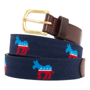 Democrat needlepoint belt with a navy blue background showing a repeating pattern of evenly spaced democrat donkey logos.  Belt has a brass buckle and full grain leather backing and strap.