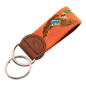 Hand-stitched duck needlepoint keychain showing a mallard drake on both sides against a blaze orange background and leather backing.  Stainless steel D-ring and keyring.