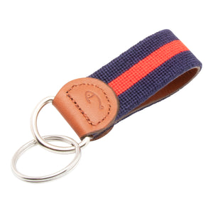 needlepoint keychain with red stripe centered on navy blue background, design wraps around to both sides, hand-stitched, leather background, stainless steel key ring, same design on both sides