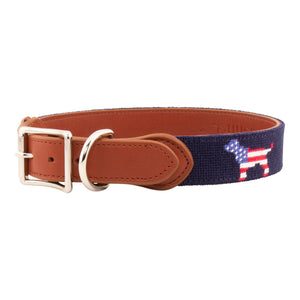 Patriotic Dog Needlepoint Dog Collar with navy blue background showing a repeating pattern of evenly spaced dog silhouette filled with the pattern of the American Flag. The dog collar has durable stainless steel and full grain leather backing and strap.