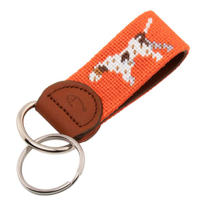 Hand-stitched Pointer Dog needlepoint keychain showing a dog in pointing stance on both sides against a blaze orange background and leather backing.  Stainless steel D-ring and keyring.