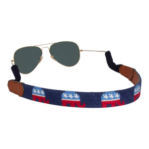 Hand-stitched republican needlepoint sunglass strap showing a republican elephant against a navy blue background with sturdy cotton covered silicone ear connectors and a soft leather backing