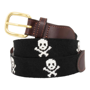 Jolly Roger Needlepoint Belt with black background showing a repeating pattern of evenly spaced white skull and crossbones pattern. Belt has a brass buckle and full grain leather backing and strap.
