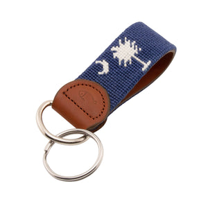 needlepoint keychain showing South Carolina State Flag against navy blue background, Palmetto and crescent, same design on both sides hand-stitched, leather backing with stainless steel keyring