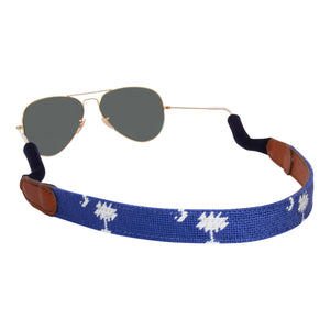 Hand-stitched South Carolina Flag needlepoint sunglass strap showing palmetto and crescent against a blue background with sturdy cotton covered silicone ear connectors and a soft leather backing