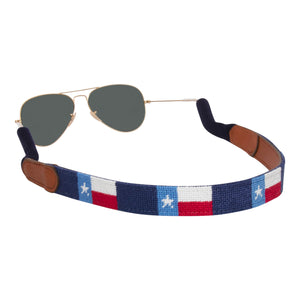 Hand-stitched Texas Flag needlepoint sunglass strap showing the Texas Flag against a navy blue background with sturdy cotton covered silicone ear connectors and a soft leather backing