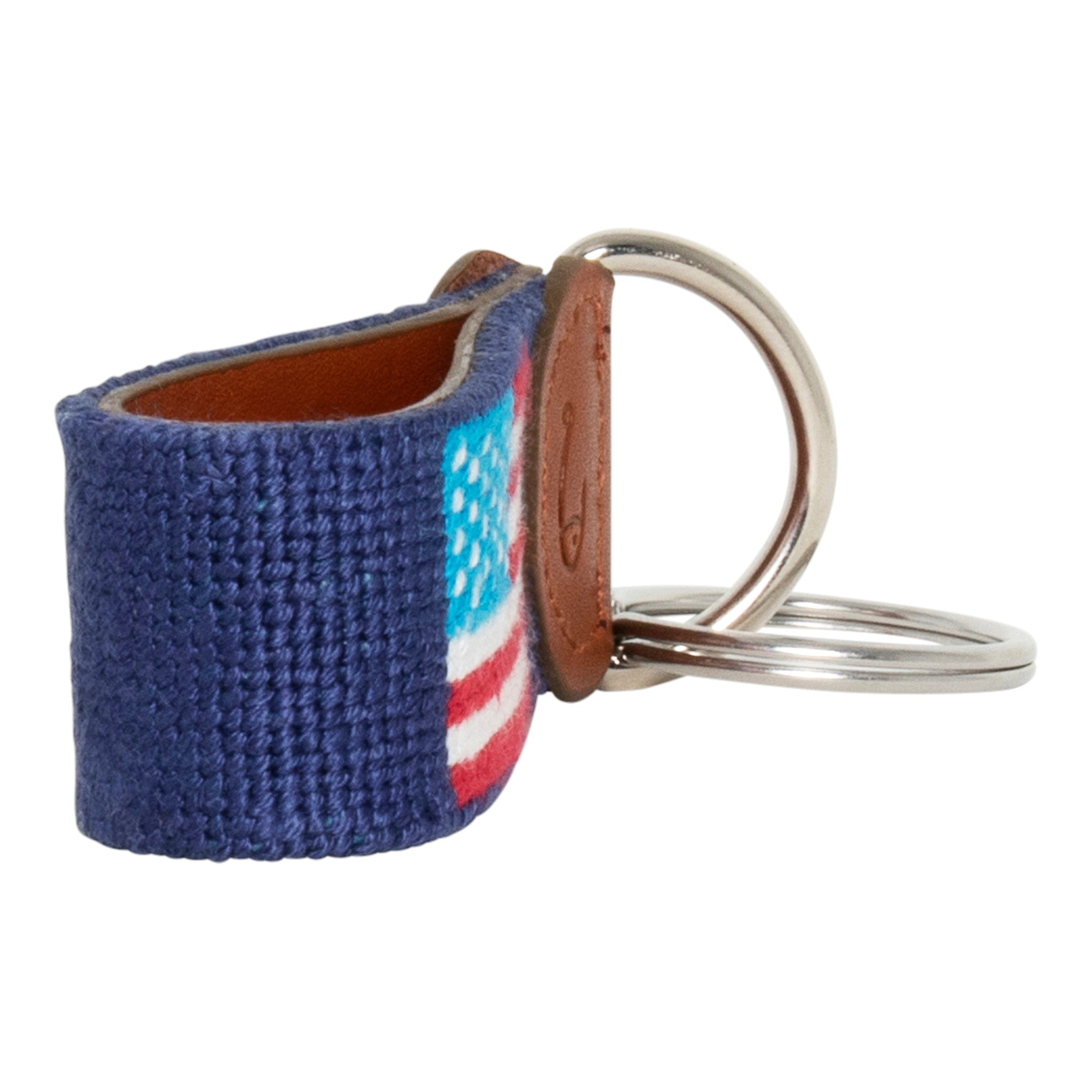 Hand-stitched American Flag needlepoint keychain showing American Flag on both sides against a navy blue background and leather backing.  Stainless steel D-ring and keyring.