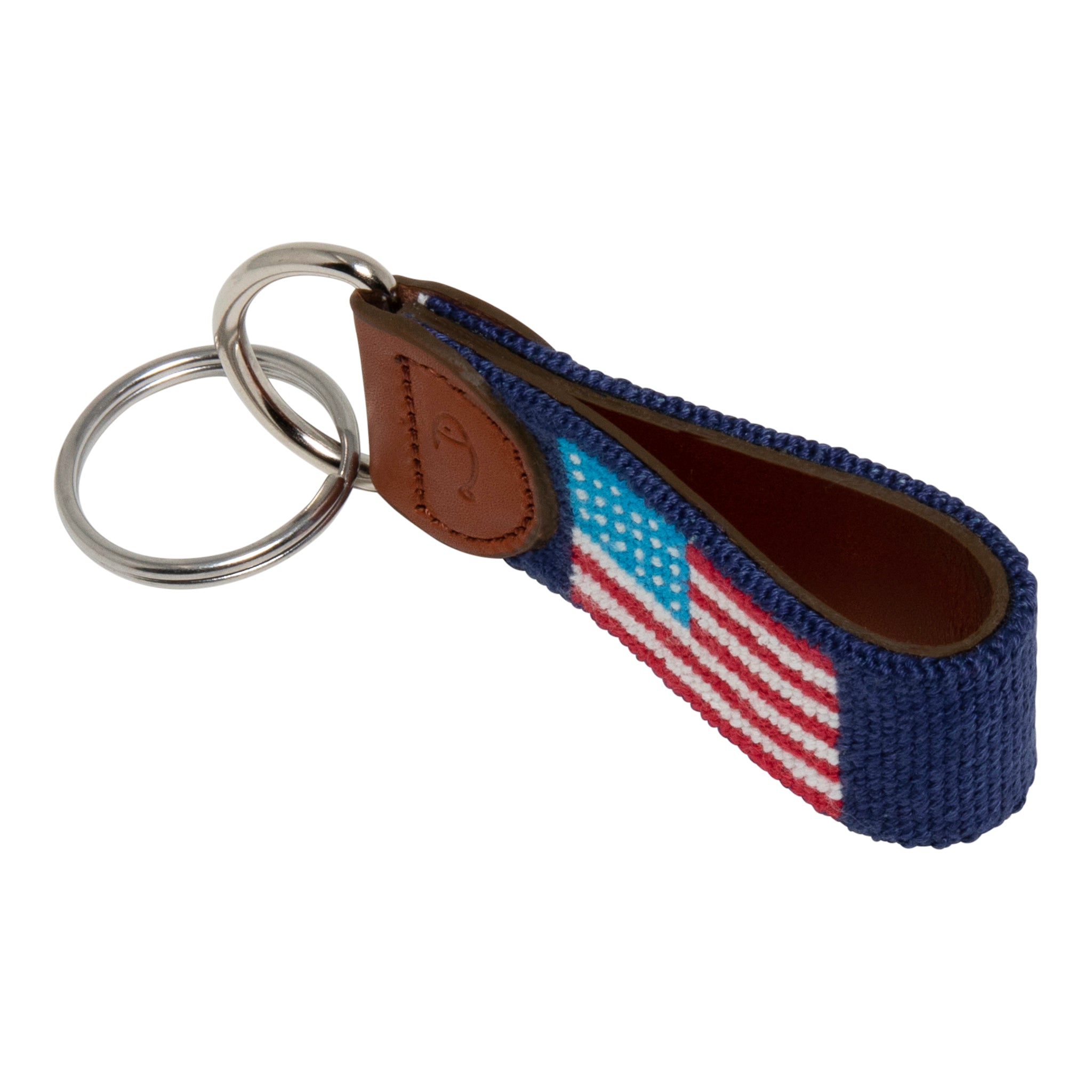 Hand-stitched American Flag needlepoint keychain showing American Flag on both sides against a navy blue background and leather backing.  Stainless steel D-ring and keyring.
