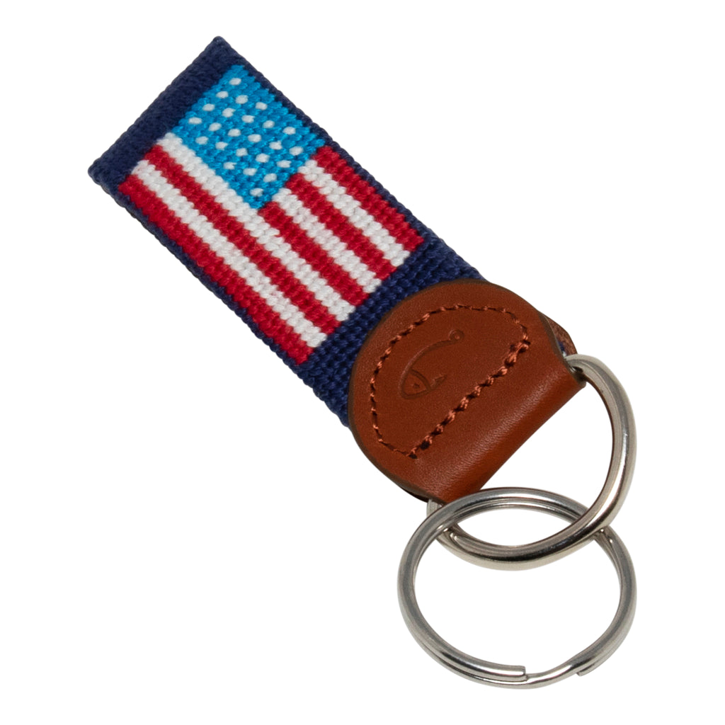 Hand-stitched American Flag needlepoint keychain showing American Flag on both sides against a navy blue background and leather backing.  Stainless steel D-ring and keyring.