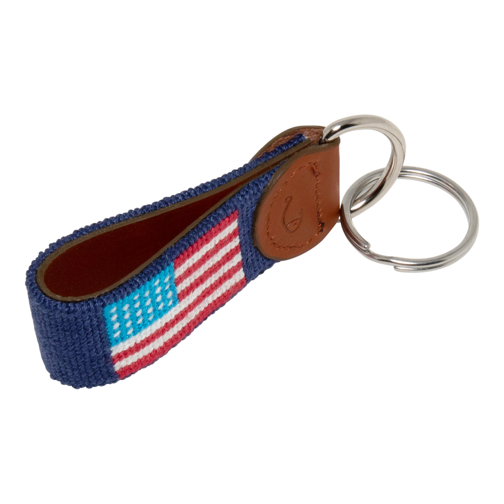 Hand-stitched American Flag needlepoint keychain showing American Flag on both sides against a navy blue background and leather backing.  Stainless steel D-ring and keyring.
