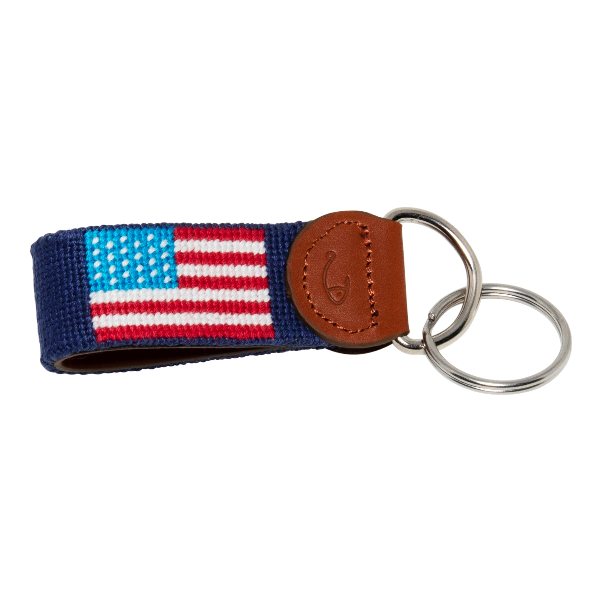 Hand-stitched American Flag needlepoint keychain showing American Flag on both sides against a navy blue background and leather backing.  Stainless steel D-ring and keyring.