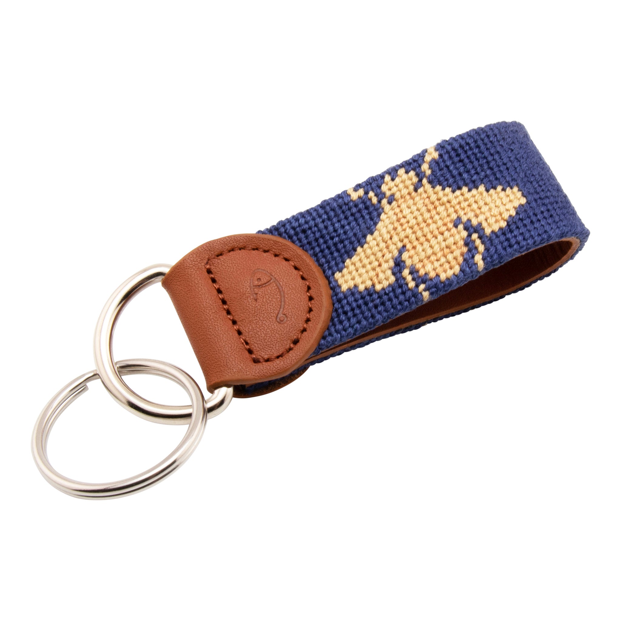 A blue key fob with a needlepoint design of a honey bee on a brown leather strap, paired with a stainless steel key ring.