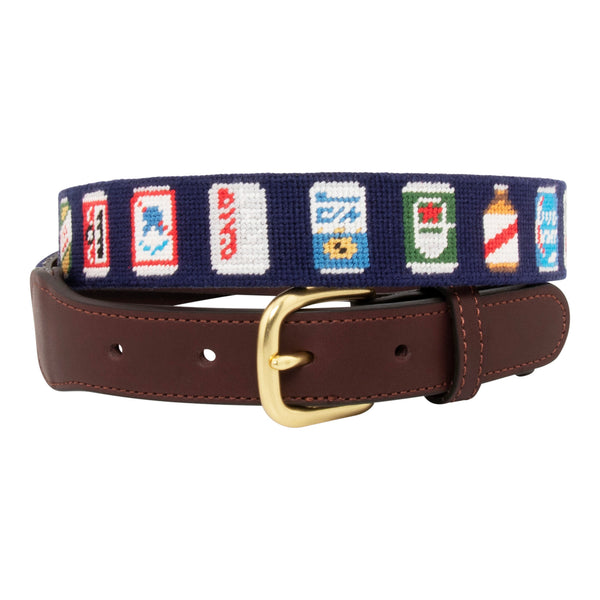 Front view of Beer Can Needlepoint Belt with navy blue background showing a repeating pattern of popular beer cans around the belt. Belt has a brass buckle and full grain leather backing and strap.