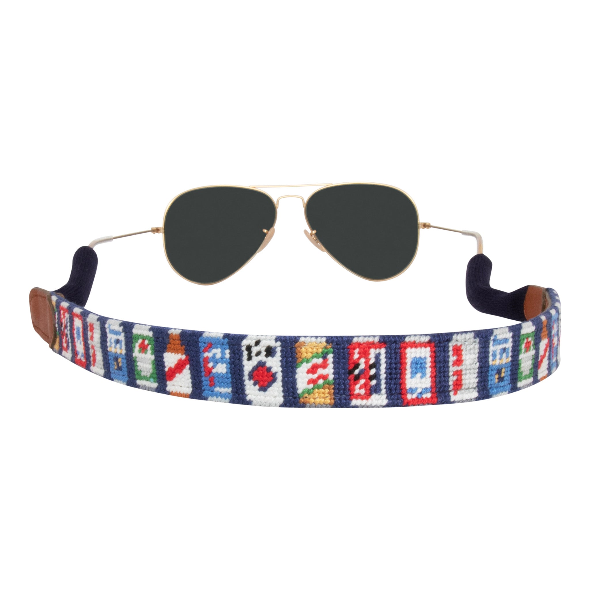 Back view beer themed needlepoint sunglass strap showing popular beer cans against a navy blue background with sturdy cotton covered silicone ear connectors and a soft leather backing