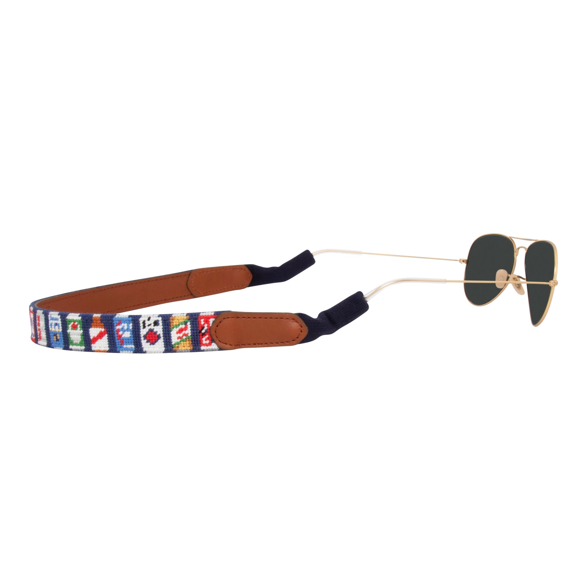 Side view beer themed needlepoint sunglass strap showing popular beer cans against a navy blue background with sturdy cotton covered silicone ear connectors and a soft leather backing