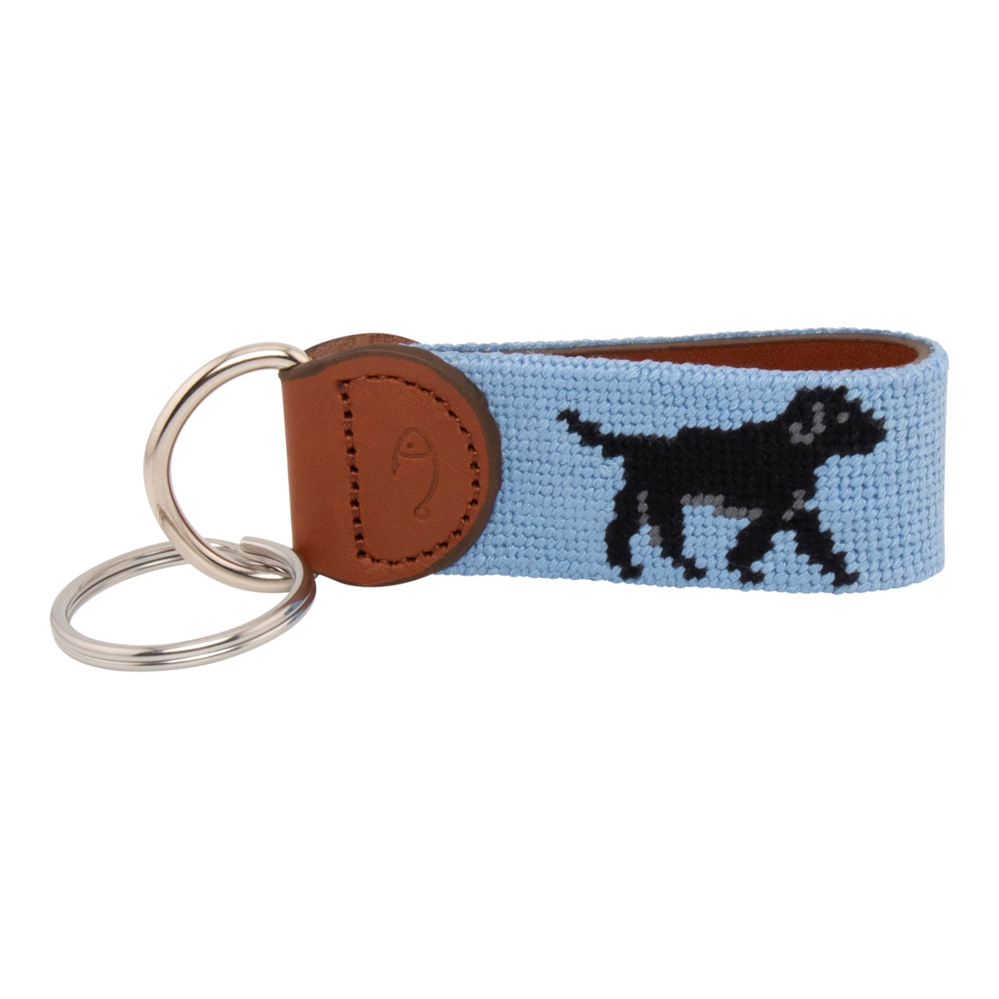 Hand-stitched black Labrador needlepoint keychain showing a black lab on both sides against a light blue background and leather backing.  Stainless steel D-ring and keyring.