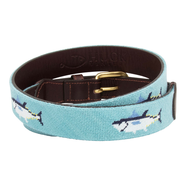 Bluefin Tuna Needlepoint Belt with light blue background showing a repeating pattern of evenly spaced blue fin tuna fish around the belt. Belt has a brass buckle and full grain leather backing and strap.