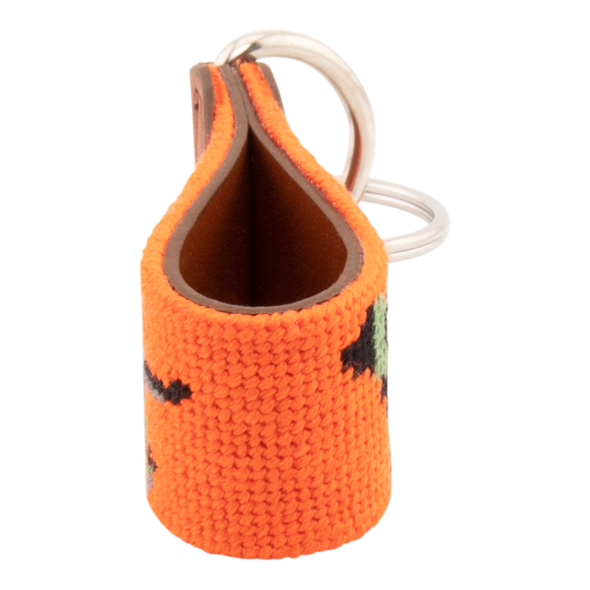 Needlepoint keychain with jungle camouflaged dog against blaze orange background, leather backing, stainless steel key ring, same pattern on both sides
