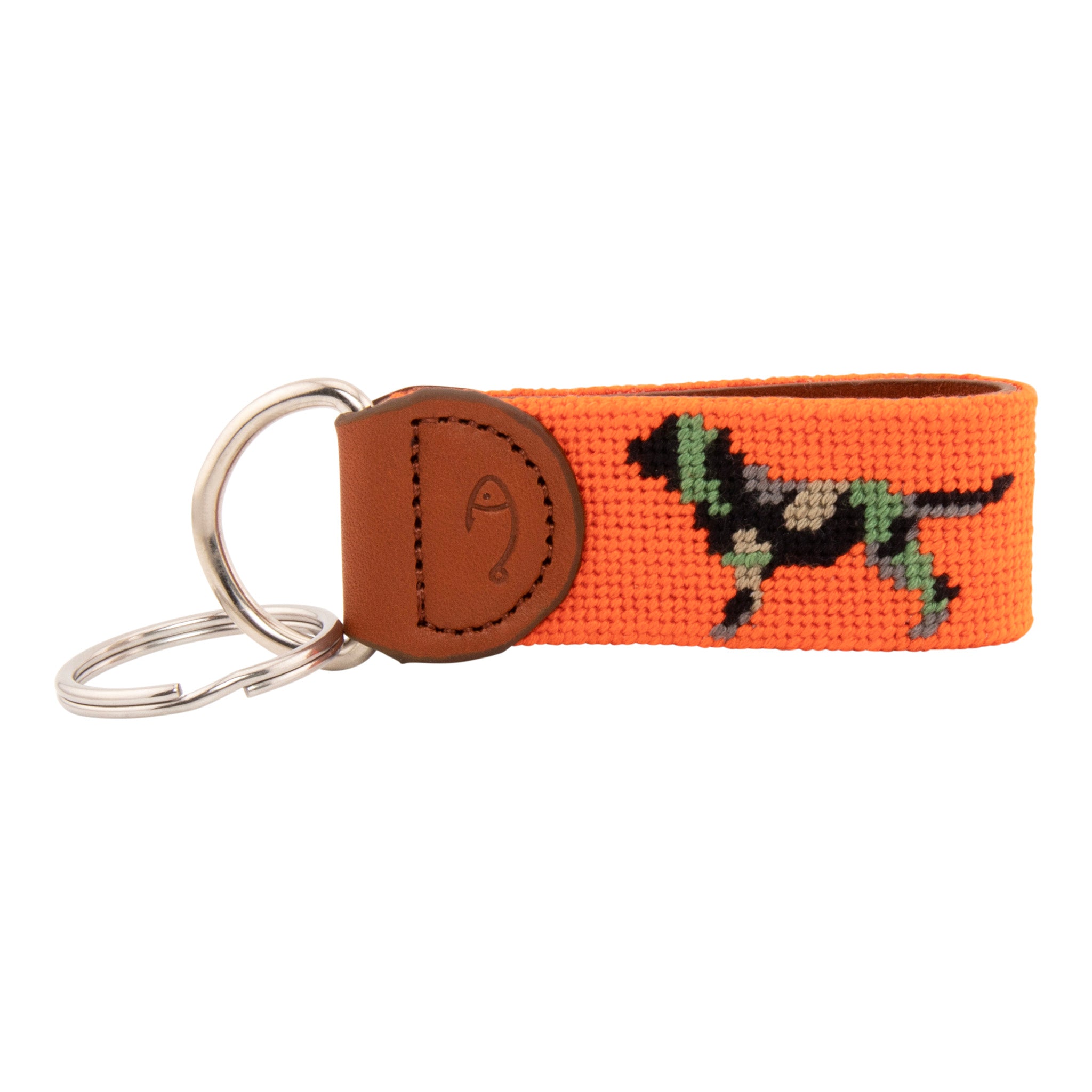 Needlepoint keychain with jungle camouflaged dog against blaze orange background, leather backing, stainless steel key ring, same pattern on both sides