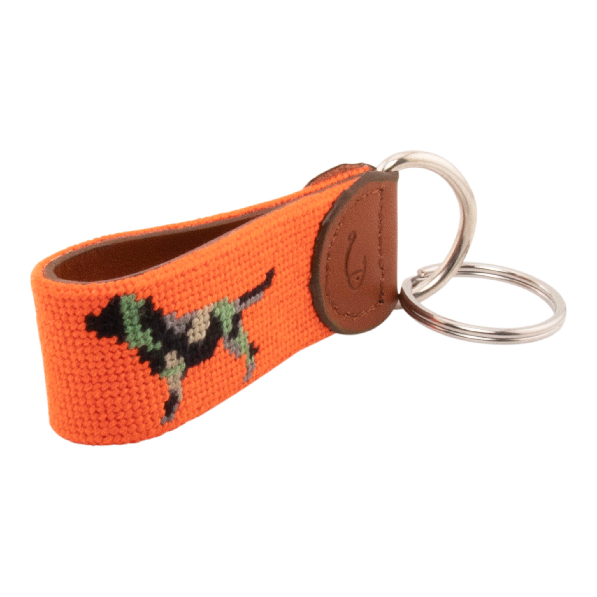 Needlepoint keychain with jungle camouflaged dog against blaze orange background, leather backing, stainless steel key ring, same pattern on both sides