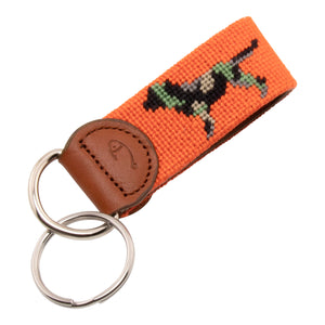 Needlepoint keychain with jungle camouflaged dog against blaze orange background, leather backing, stainless steel key ring, same pattern on both sides