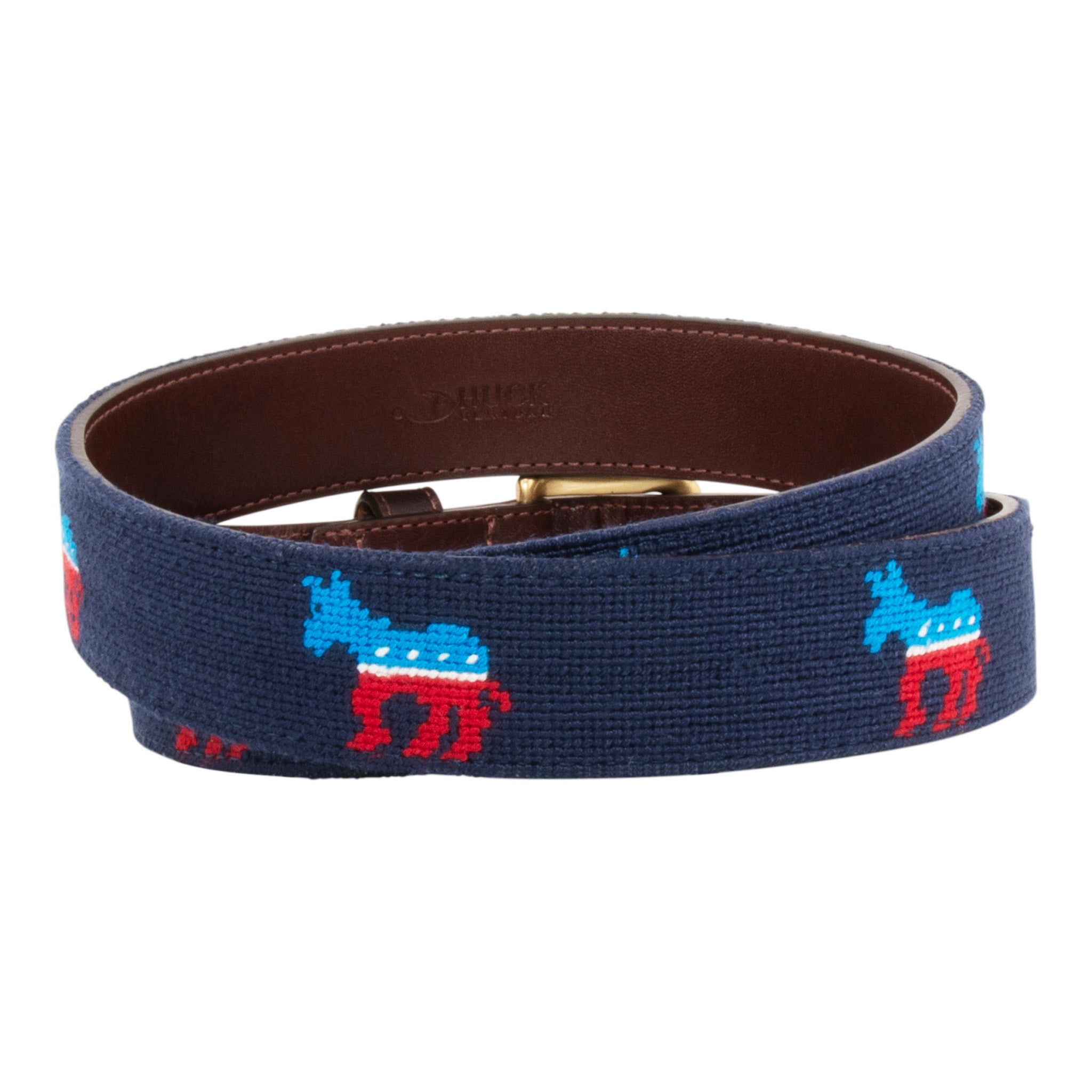 Democrat needlepoint belt with a navy blue background showing a repeating pattern of evenly spaced democrat donkey logos.  Belt has a brass buckle and full grain leather backing and strap.