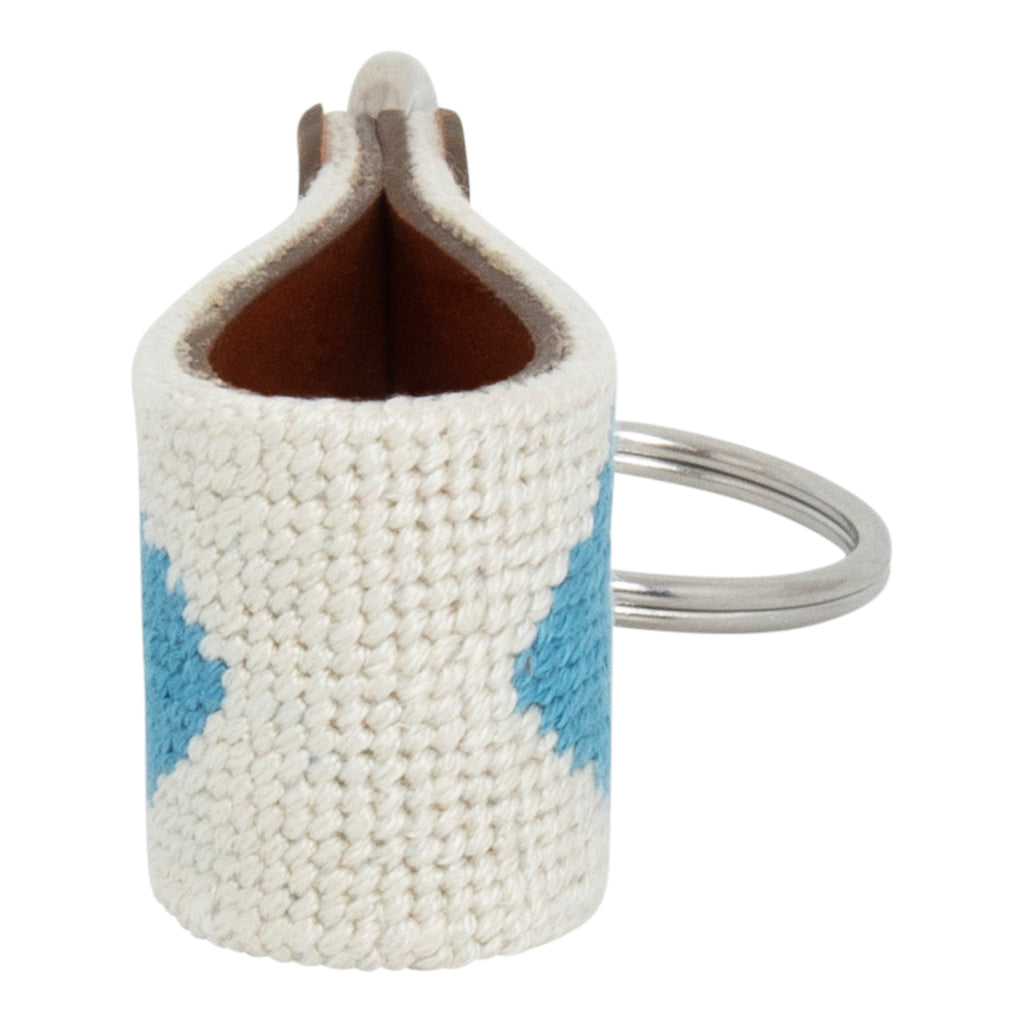 Hand-stitched evil eye needlepoint keychain showing an evil eye on both sides against a stone colored background and leather backing.  Stainless steel D-ring and keyring.