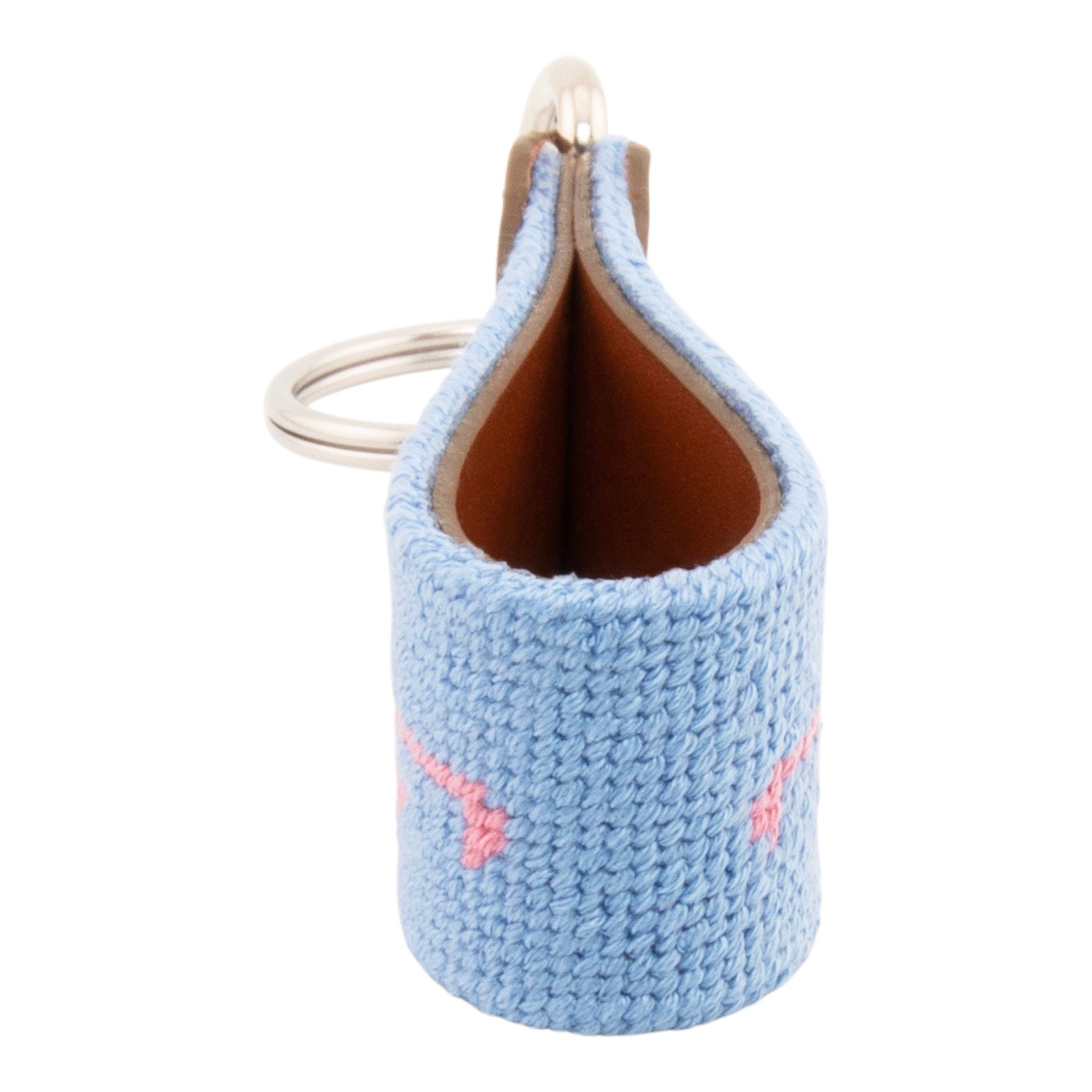 needlepoint keychain showing a pink flamingo on both sides against a light blue background, hand-stitched, leather backing, and stainless steel hardware