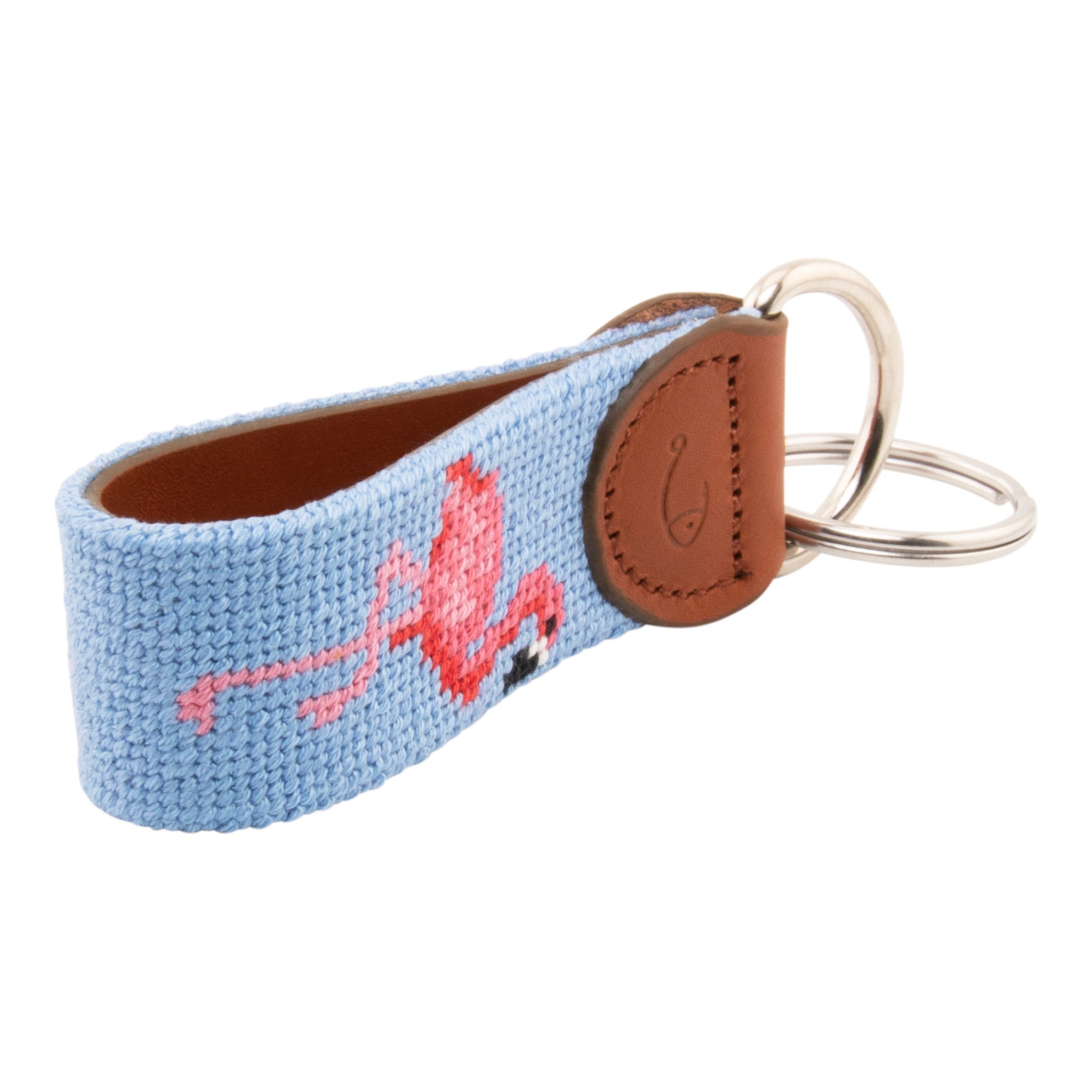 needlepoint keychain showing a pink flamingo on both sides against a light blue background, hand-stitched, leather backing, and stainless steel hardware