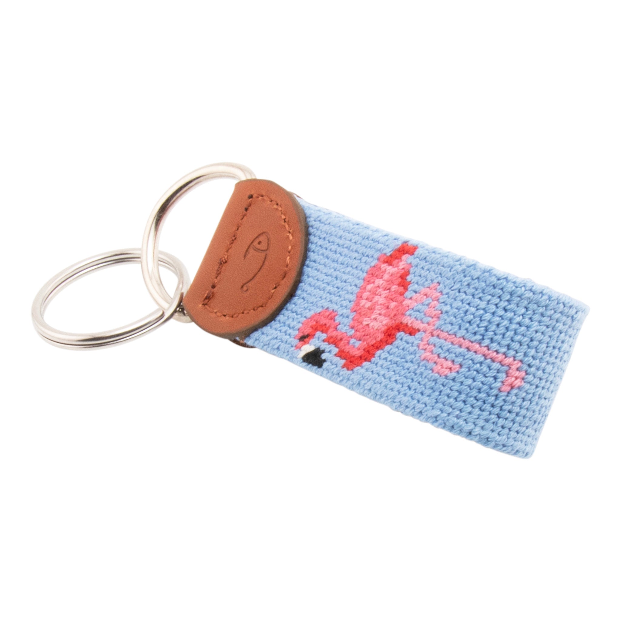 needlepoint keychain showing a pink flamingo on both sides against a light blue background, hand-stitched, leather backing, and stainless steel hardware