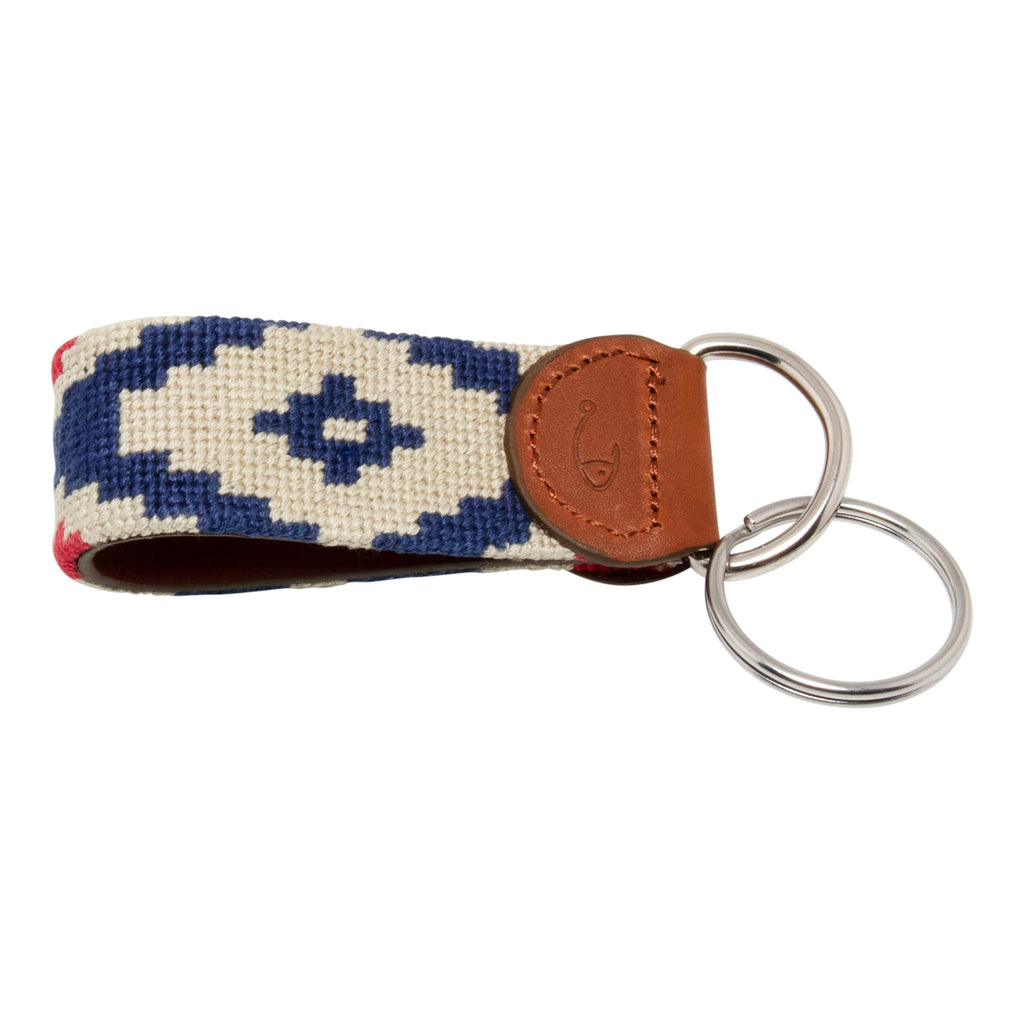 Hand-stitched Gaucho needlepoint keychain showing a red white and blue gaucho pattern on both sides with leather backing.  Stainless steel D-ring and keyring.