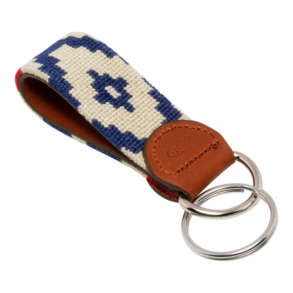 Hand-stitched Gaucho needlepoint keychain showing a red white and blue gaucho pattern on both sides with leather backing.  Stainless steel D-ring and keyring.