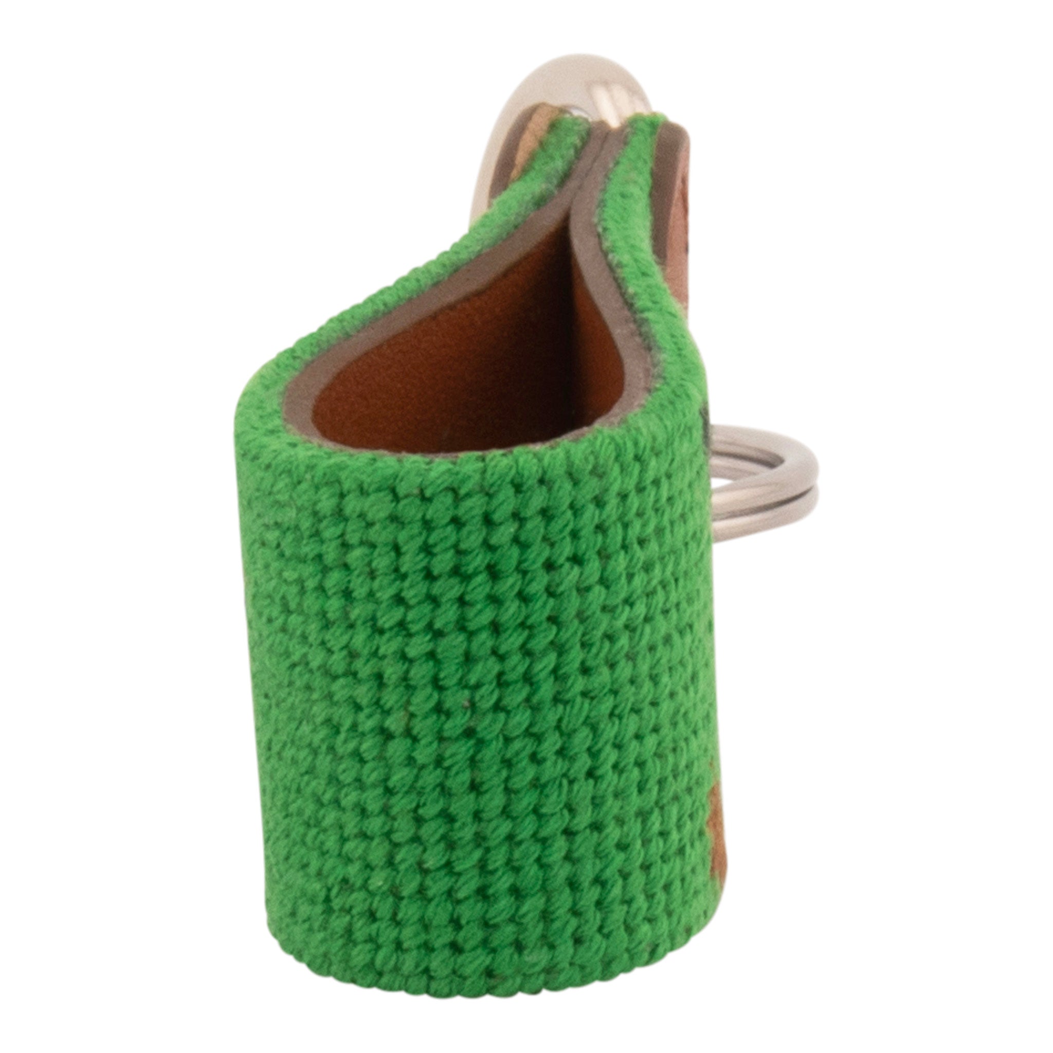 Hand-stitched golfing themed needlepoint keychain showing crossed golf clubs on both sides against a green background and leather backing.  Stainless steel D-ring and keyring.