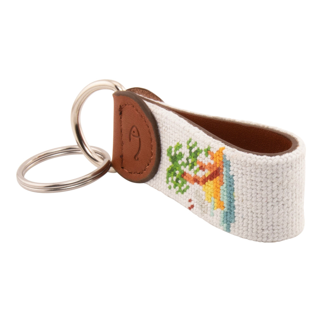 needlepoint keychain with palm tree design, same design on both sides, off white background, hand-stitched, leather background, stainless steel key ring, same design on both sides