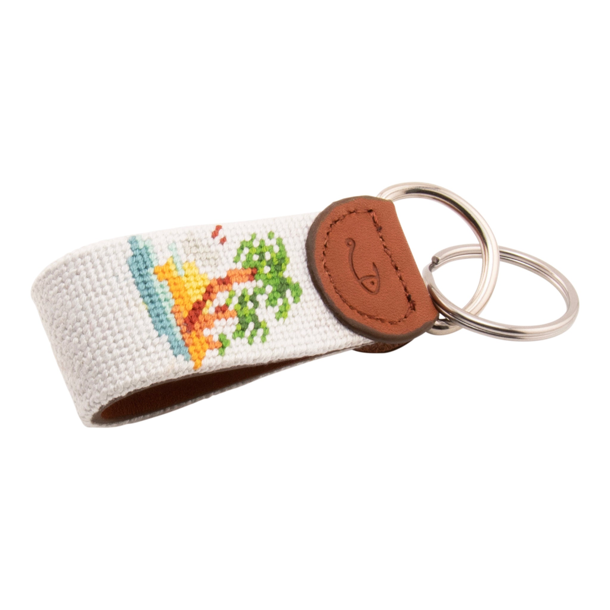 needlepoint keychain with palm tree design, same design on both sides, off white background, hand-stitched, leather background, stainless steel key ring, same design on both sides