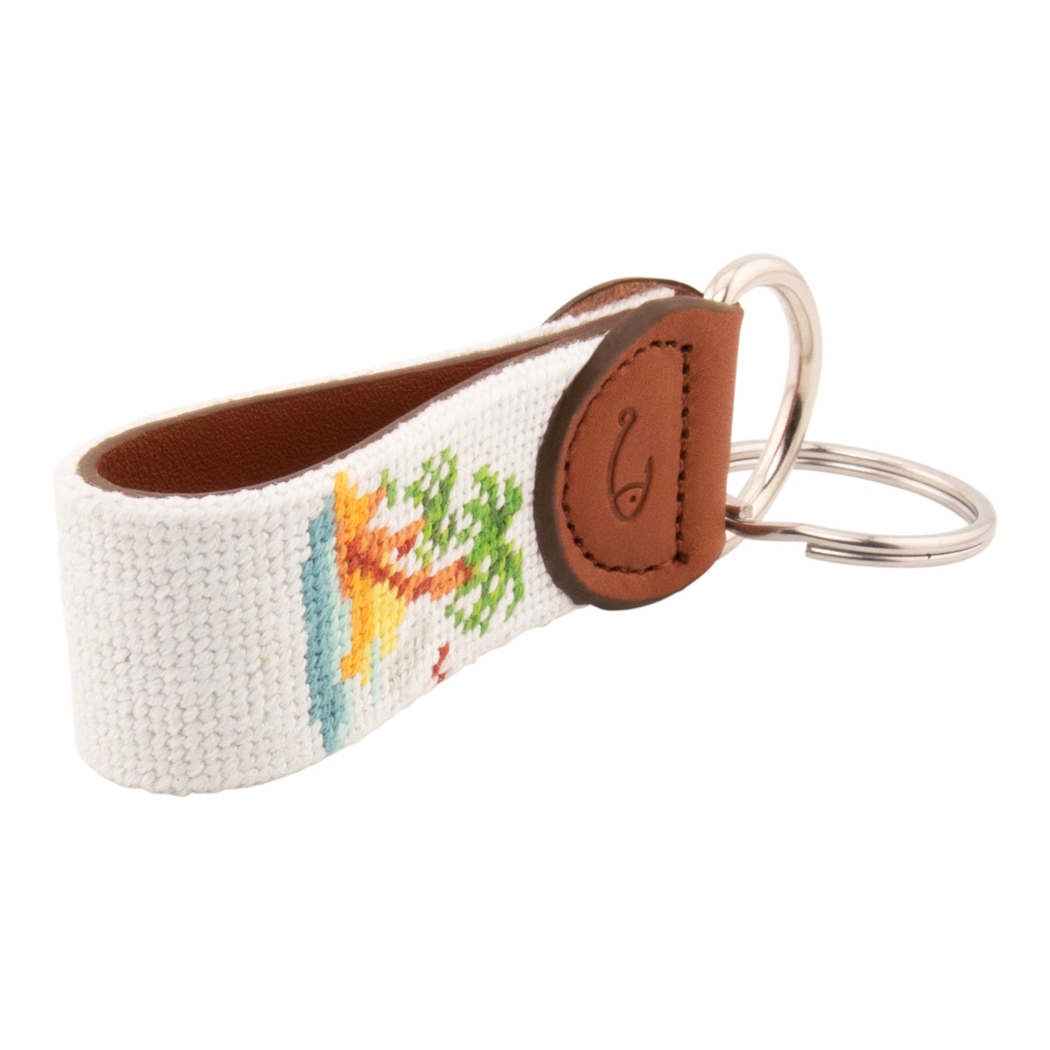 needlepoint keychain with palm tree design, same design on both sides, off white background, hand-stitched, leather background, stainless steel key ring, same design on both sides