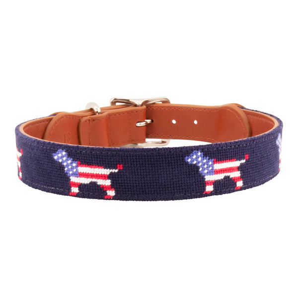 Patriotic Dog Needlepoint Dog Collar with navy blue background showing a repeating pattern of evenly spaced dog silhouette filled with the pattern of the American Flag. The dog collar has durable stainless steel and full grain leather backing and strap.