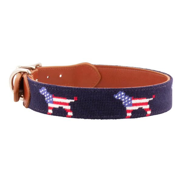 Patriotic Dog Needlepoint Dog Collar with navy blue background showing a repeating pattern of evenly spaced dog silhouette filled with the pattern of the American Flag. The dog collar has durable stainless steel and full grain leather backing and strap.