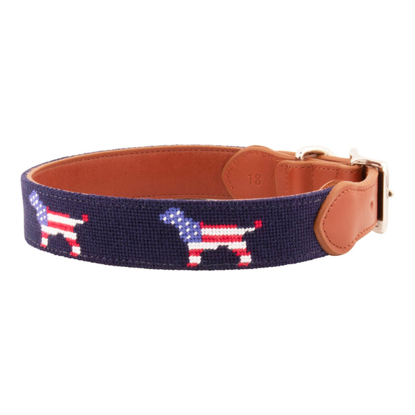 Patriotic Dog Needlepoint Dog Collar with navy blue background showing a repeating pattern of evenly spaced dog silhouette filled with the pattern of the American Flag. The dog collar has durable stainless steel and full grain leather backing and strap.