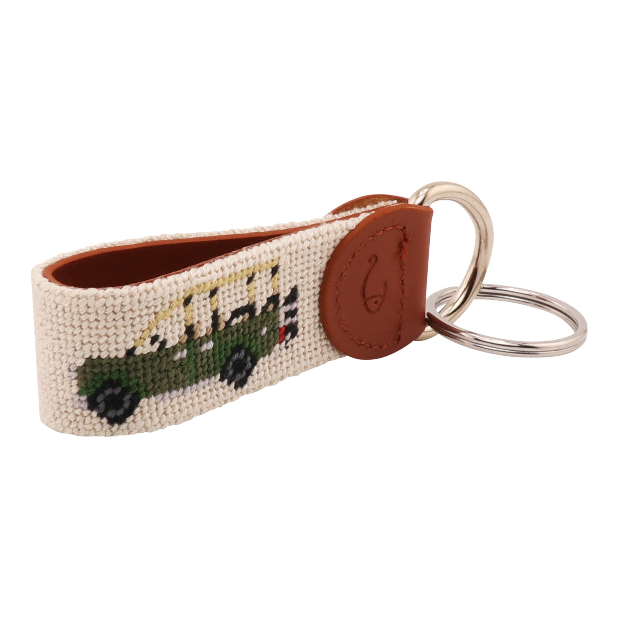 Hand-stitched Safari Needlepoint Key Fob with green safari vehicle design, full-grain leather backing, and stainless steel key ring by Huck Venture.