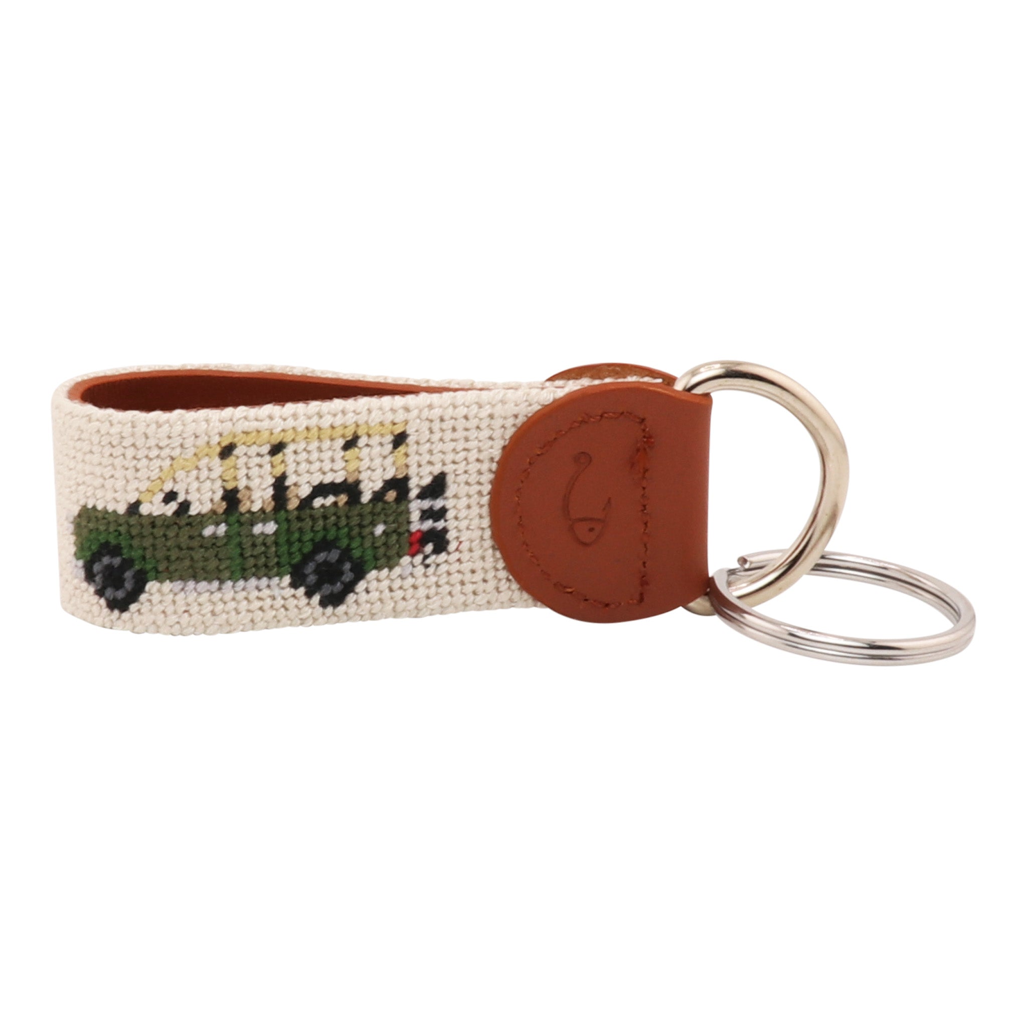 Hand-stitched Safari Needlepoint Key Fob with green safari vehicle design, full-grain leather backing, and stainless steel key ring by Huck Venture.