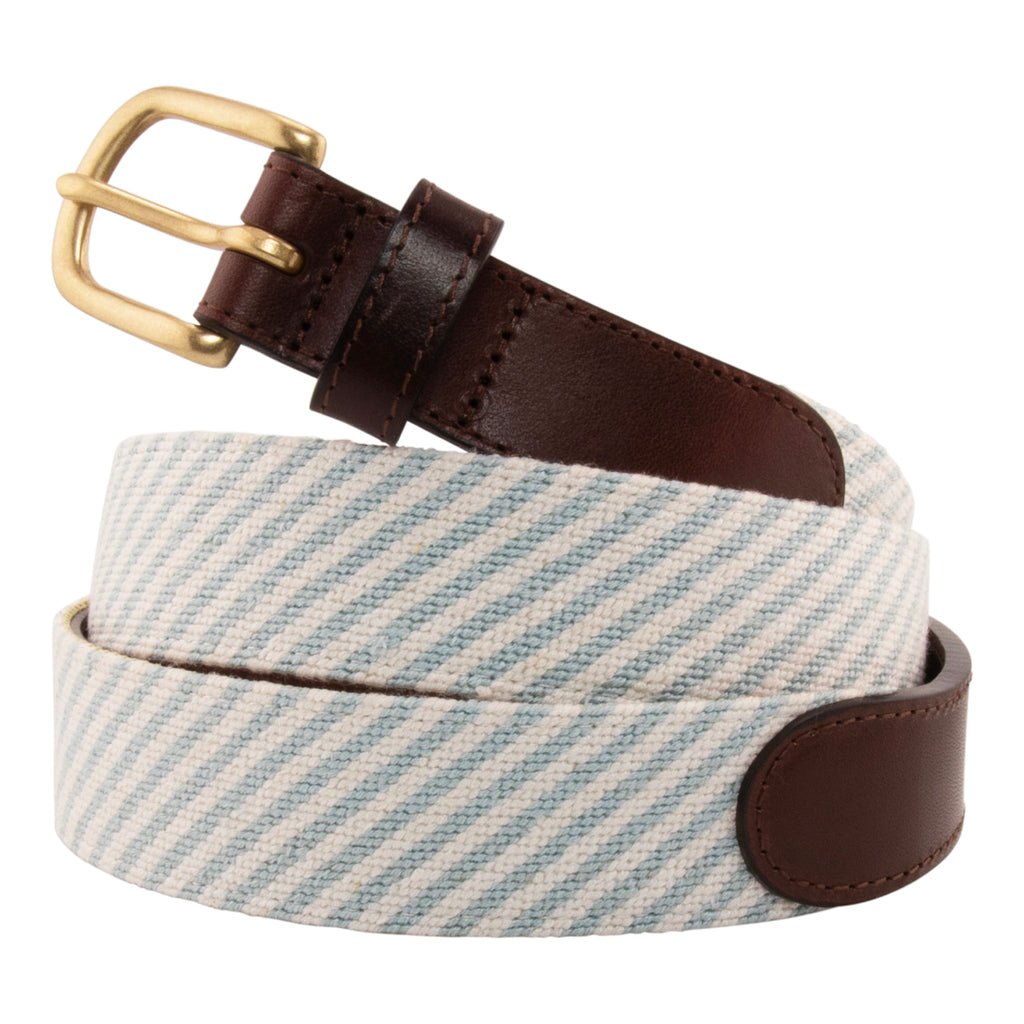 Seersucker Needlepoint Belt with a classic blue and white seersucker pattern.  Belt has a brass buckle and full grain leather backing and strap.